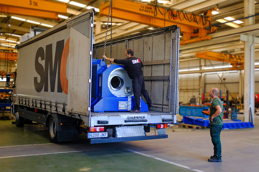 An SMG truck being loaded with a crane