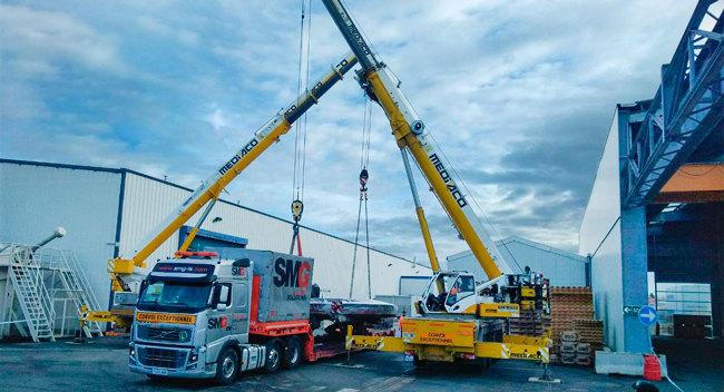 grua descargando camión de SMG